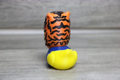 Toy figure with tiger head and yellow body on a gray background